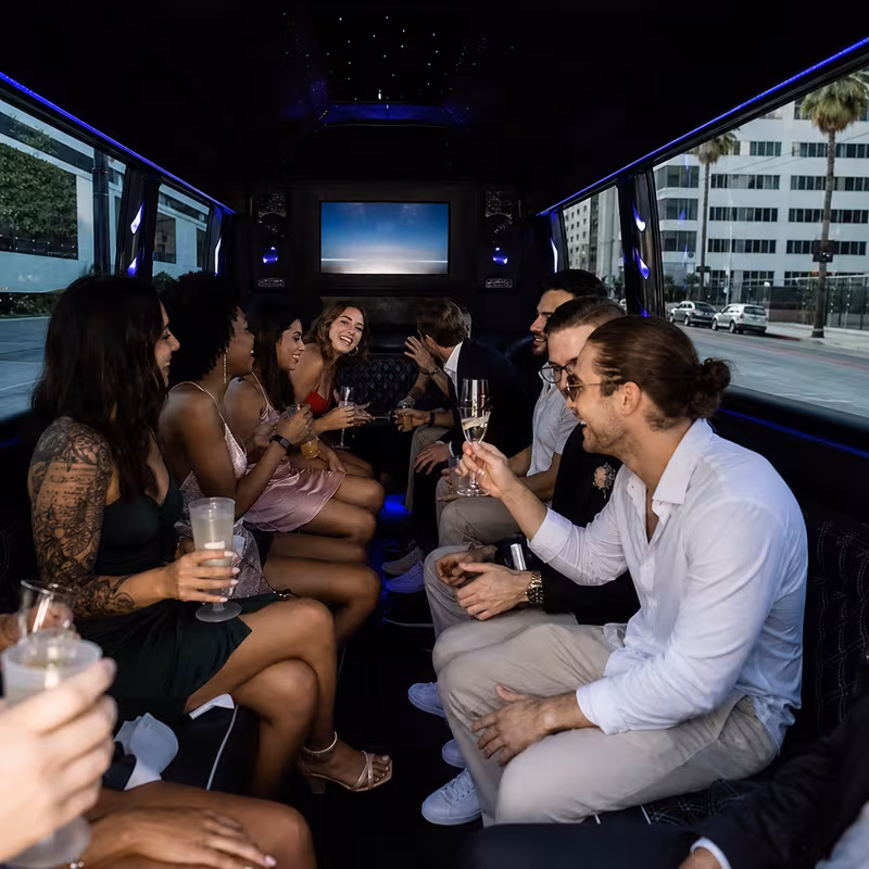 Party bus interior with wraparound leather seating and LED lighting in Los Angeles