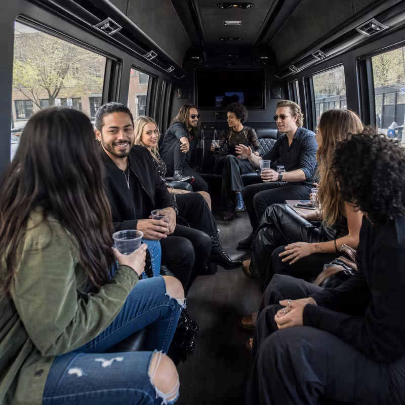 Group boarding a white charter bus for Concert Transportation transportation in Los Angeles