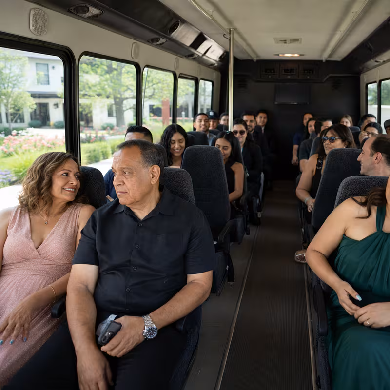 Group boarding a white charter bus for Private Event Transportation transportation in Los Angeles