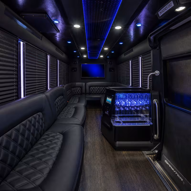 Party bus interior with wraparound leather seating and LED lighting in Los Angeles