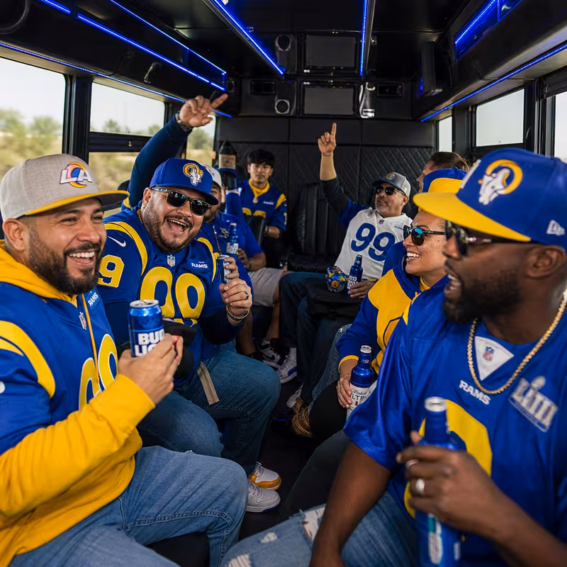 Group boarding a white charter bus for Sporting Event Transportation transportation in Los Angeles