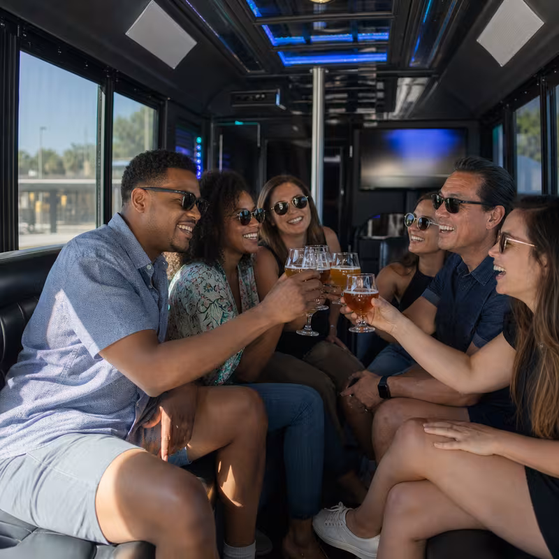 Group boarding a white charter bus for Winery & Brewery Tour Transportation transportation in Los Angeles